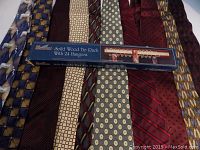 10 silk ties laid out showing various patterns and included boxed wood tie rack in packaging.