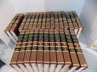 Full view of all 27 volumes in one row with clear visible gold and maroon spines.