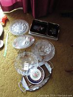 Overview of cut glass bowls including fruit bowl, divided dish, and small ceramic bowl stacked on metal tray suitable for serving