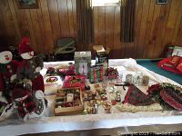 Wide view of lot on table showing assorted holiday decorations including snowman figures, wreaths, ornaments, and other items.