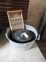 Wash board inside galvanized tub with canning pot.