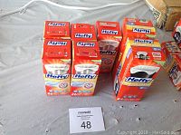 Seven boxes of Hefty trash bags and kitchen bags of assorted sizes and counts displayed on a surface.