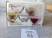 Box showing brand Libbey, set containing 8 small glass bowls with lids.
