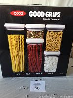 Photo of the box front showing OXO Good Grips 5 piece POP container set with visual of filled containers showing pasta, nuts, snack sticks and cubes inside.