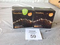 Two black boxes of DecorNova LED string lights with warm white lighting, each box labeled with '3M 40LED' and 'Pack of 2 pcs'.