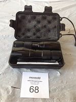 Photo of two black flashlights in open black zippered carrying case with foam padding inside.