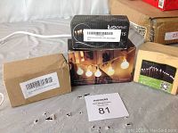 Four boxed sets of assorted battery operated LED string lights arranged on a surface.