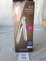 Photo of the John Frieda ionic 1 inch hair straightener box showing product image, model info, and branding.