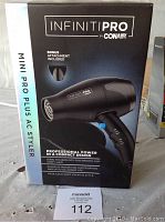 Photo of the Infiniti PRO by Conair Mini Pro Plus AC Styler box showing the hair dryer and attachment.
