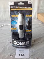 CONAIR all-in-one beard, mustache, nose and ear trimmer in original packaging showing product and attachments
