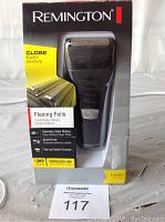 Boxed Remington F3000 facial shaver with key features shown on packaging including flexing foils, stainless steel blades, quiet drive, and pop-up detail trimmer. Product is black and appears new in box.