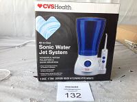 Photo of front box and unit with large blue water tank and dial control on the base showing product branding and features.