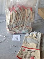 Pack of 12 SCHWERIN-V large work gloves size 10 still in plastic packaging and one glove outside for display showing markings and build.