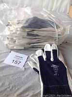 Photo showing twelve pairs of Condor work gloves size 9 stacked inside a clear plastic bag with one glove pair displayed in front.