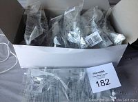 White cardboard box containing one dozen individually packaged clear Ironwear work glasses, style Harmony, style number 3550CC, visible on packaging and glasses.