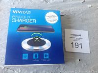 Photo of Vivitar Wireless QI Charger box showing compatibility and features on front.