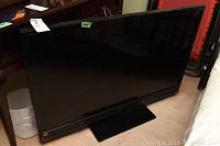 Front angled view of the Sony 46 inch flat screen television showing the entire screen and stand.