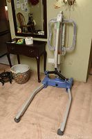 Full view of lift showing steel frame and open base with casters