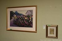 Wide shot showing both framed artworks on a wall, highlighting their relative sizes.