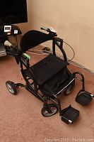 Front angle showing padded backrest, hand grips and front wheels of the Airgo walker wheelchair combo.