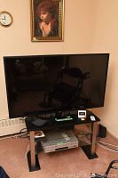 Front view of 55in LG TV on stand with DVD/VCR below