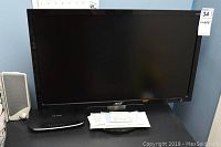 Front view showing Acer 26 inch monitor, TP-Link modem, and one speaker on a desk.