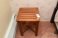 Top view of smaller wooden table showing slatted wood top and warm wood finish.