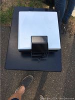 Closed panini maker showing white and black exterior with handle.