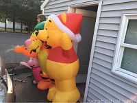 Side view of Disney inflatable set showing Winnie the Pooh in Santa hat, Tigger, and Piglet