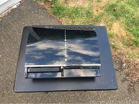 Top view of Sony PlayStation 3 console showing reflective surface and scratches