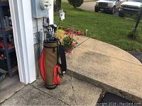 Full view of the golf bag standing outside garage with clubs inside