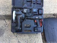 Craftsman drills and trimsaw set packed in black molded plastic case with chargers and batteries.