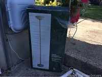 Photo of the UltraLux 300W halogen floor lamp in its original box showing packaging condition.