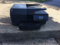 Side view of the HP Officejet Pro 6830 showing printer body and ink cartridge at base of the printer.