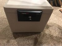 Front view of the SentrySafe fireproof safe with locking panel and keyhole.