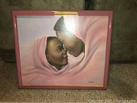 Full view of the framed painting showing a mother and child touching foreheads, wrapped in pink.