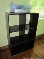Front view of dark brown six-cubby storage unit showing two columns and three rows of square compartments.