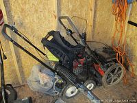 Overview showing Ryobi backpack blower with tube attached and two stump grinders