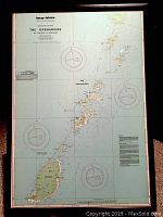 Framed nautical navigation chart titled 'The Grenadines' featuring detailed mapping of islands and navigational markers in the Caribbean, in a black wood frame with glass
