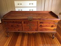 Front view of rectangular cedar chest showing brass hardware and keyhole on front panel.