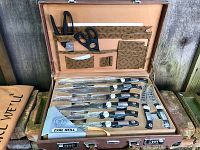 Open briefcase showing interior tray with knives and accessories