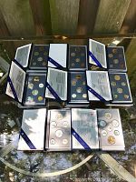 Eight sets arranged in two rows showing front presentation folders.