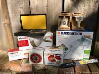 Photo showing Black & Decker hand mixer box, Thinkkitchen food press box, marble rolling pin, pie and kitchen funnels, dough press set, and a Village Inn pastry club box.