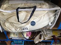 Full/queen comforter in clear zippered bag with label and black handles