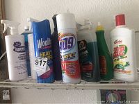 Photo showing multiple cleaning product bottles including Folex carpet spot remover, Woolite carpet cleaner, 409 carpet and stain remover, Armor All Power Wash concentrate, and Turtle Wax Zip Wax car wash and wax.