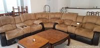 Front view of full L-shaped brown sectional sofa in living area