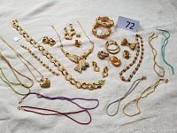 All jewelry items laid out on white cloth