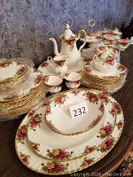 Full view of dinnerware, tea set and serving pieces arranged on table
