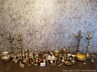 Wide shot of the collection showing all items arranged on table against floral wallpaper