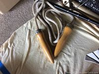 Close-up of vintage jump rope wooden handles with knotted rope